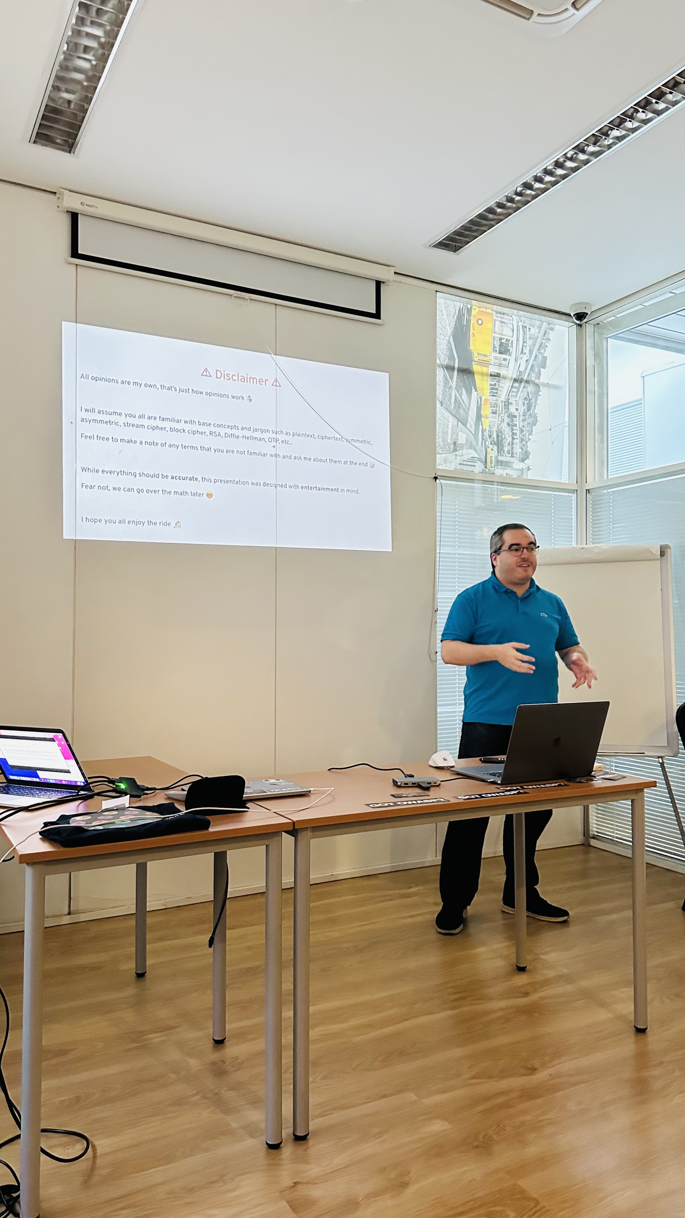OWASP Lisboa #3 A speaker in a blue polo shirt gesturing while presenting a "Disclaimer" slide with bullet points about the presentation's content.