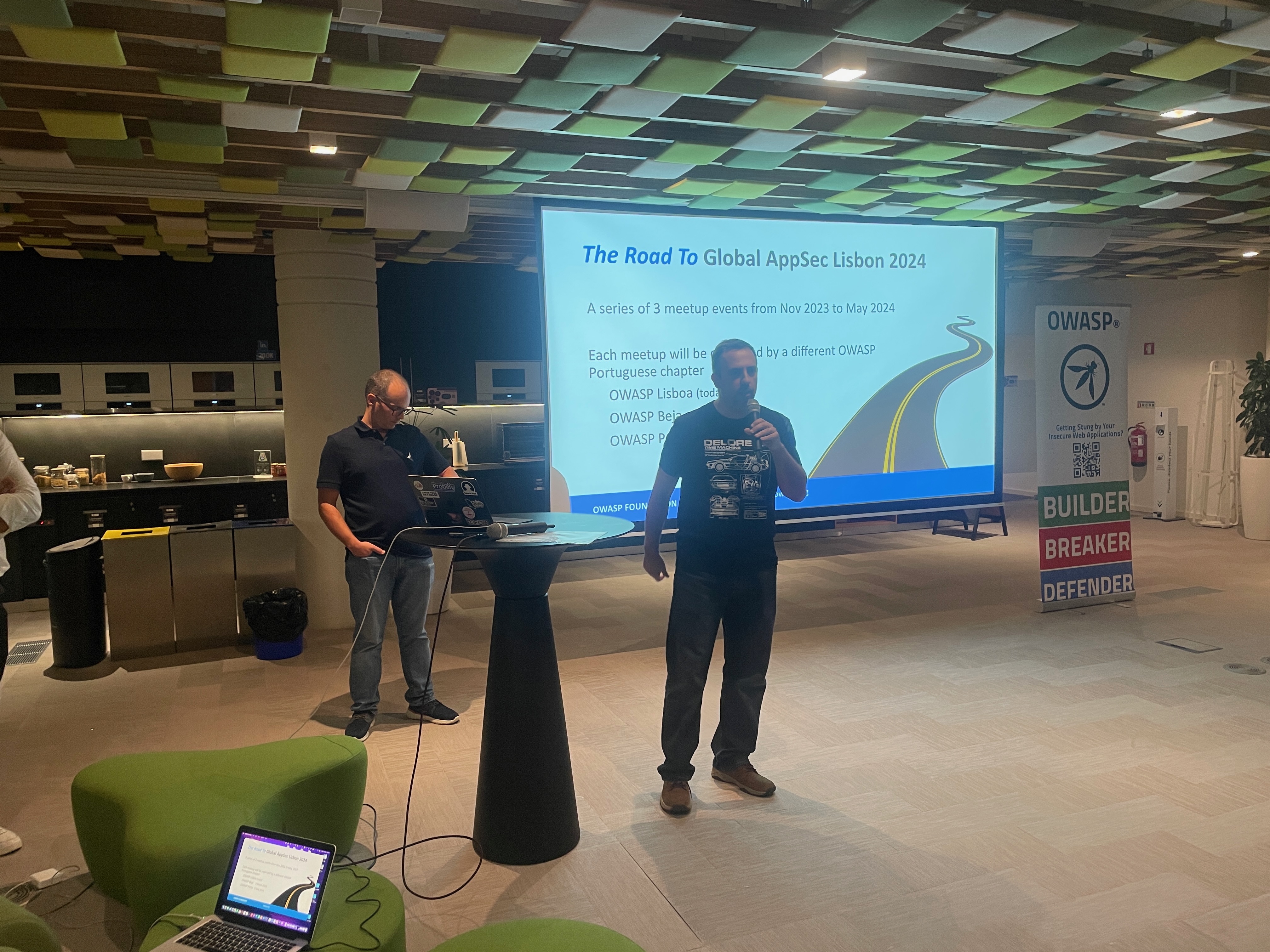 OWASP Lisboa #5 An organizer speaking into a microphone next to a slide titled "The Road To Global AppSec Lisbon 2024," outlining upcoming meetups.