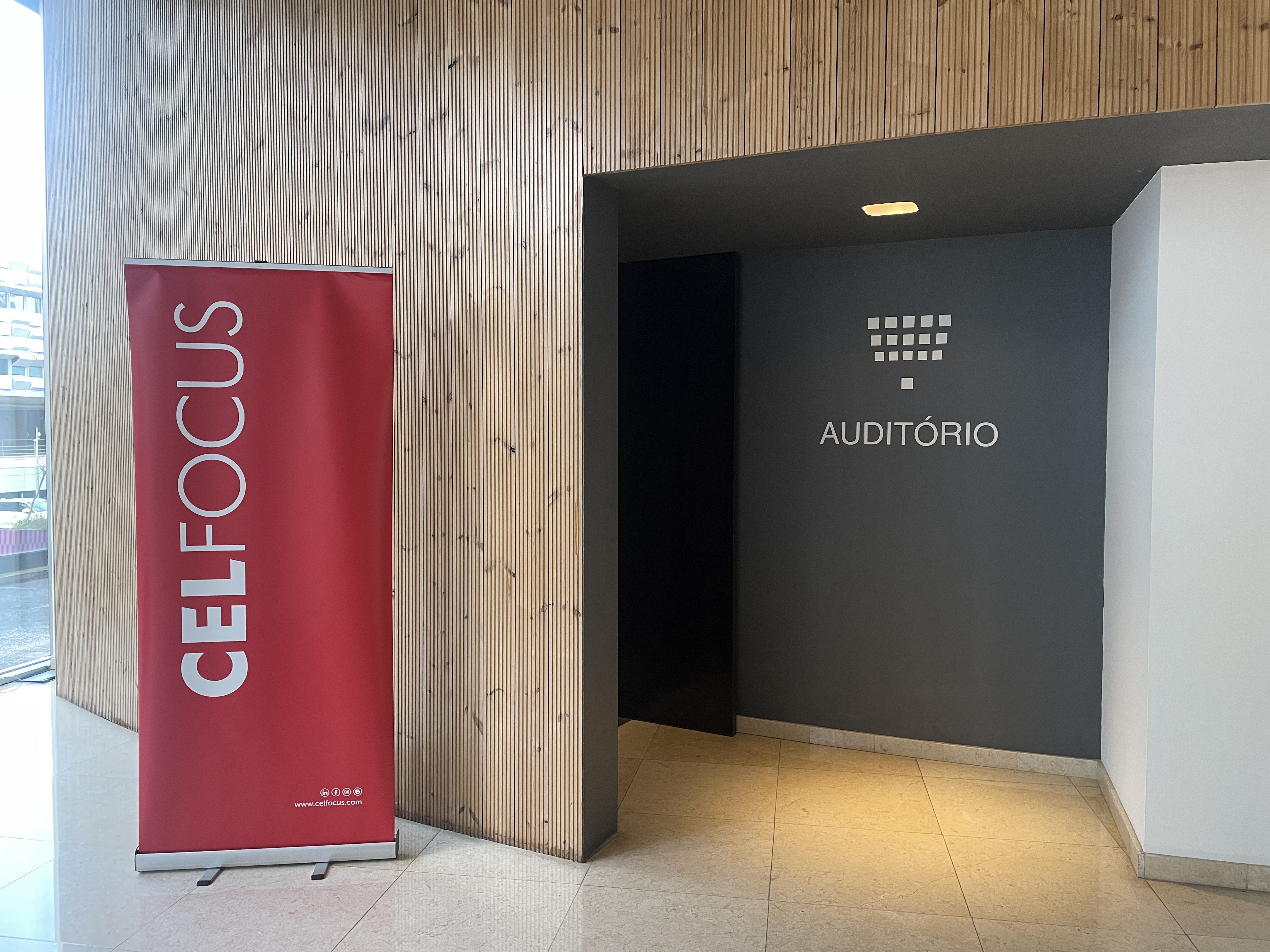 OWASP Lisboa #6 The entrance to the "Auditório" event space featuring a red vertical banner for the sponsor, Celfocus.