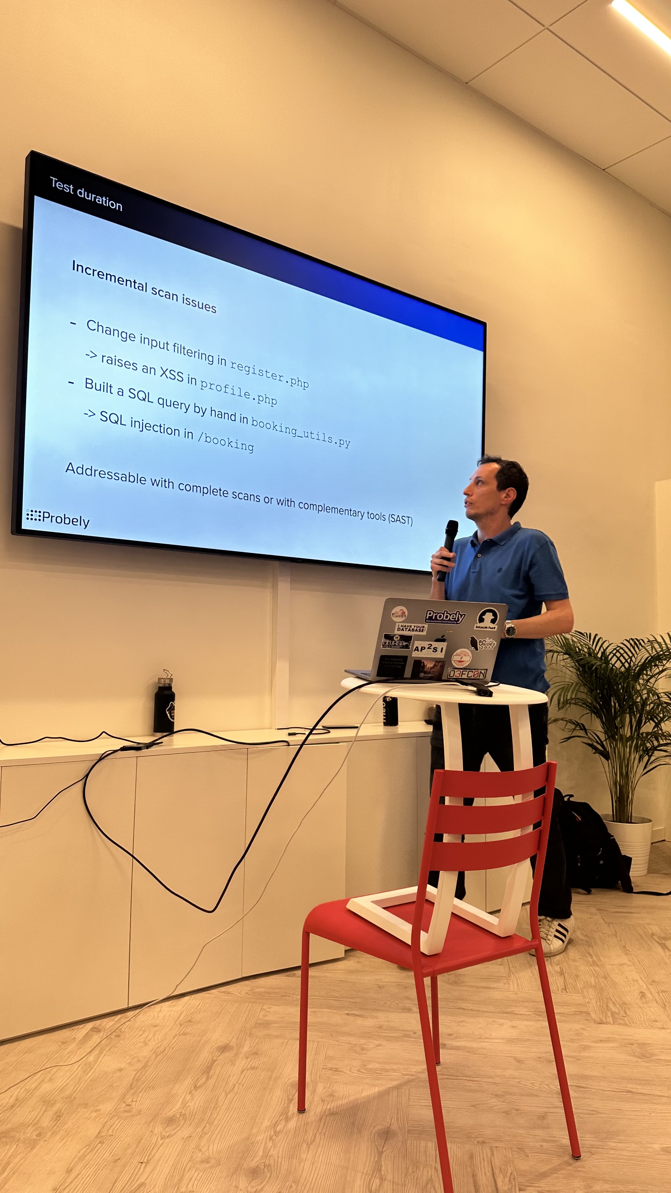 OWASP Lisboa #7 A speaker in a blue shirt presenting a technical slide titled "Incremental scan issues" with code examples, branded with the Probely logo.