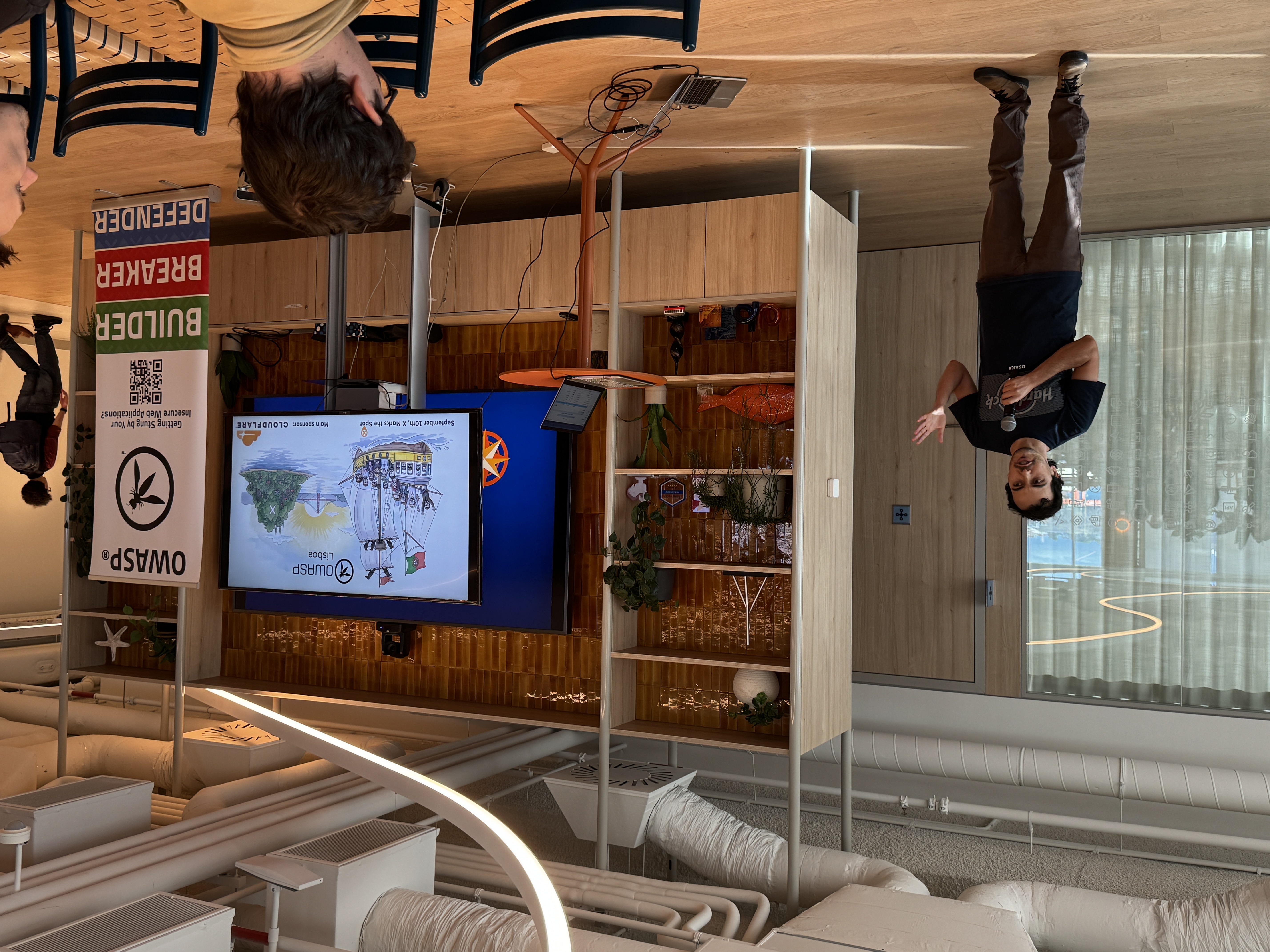 OWASP Lisboa #10 A speaker presenting the event title slide featuring a cartoon ship illustration and the text "OWASP Lisboa - September 24th - X Marks the Spot."