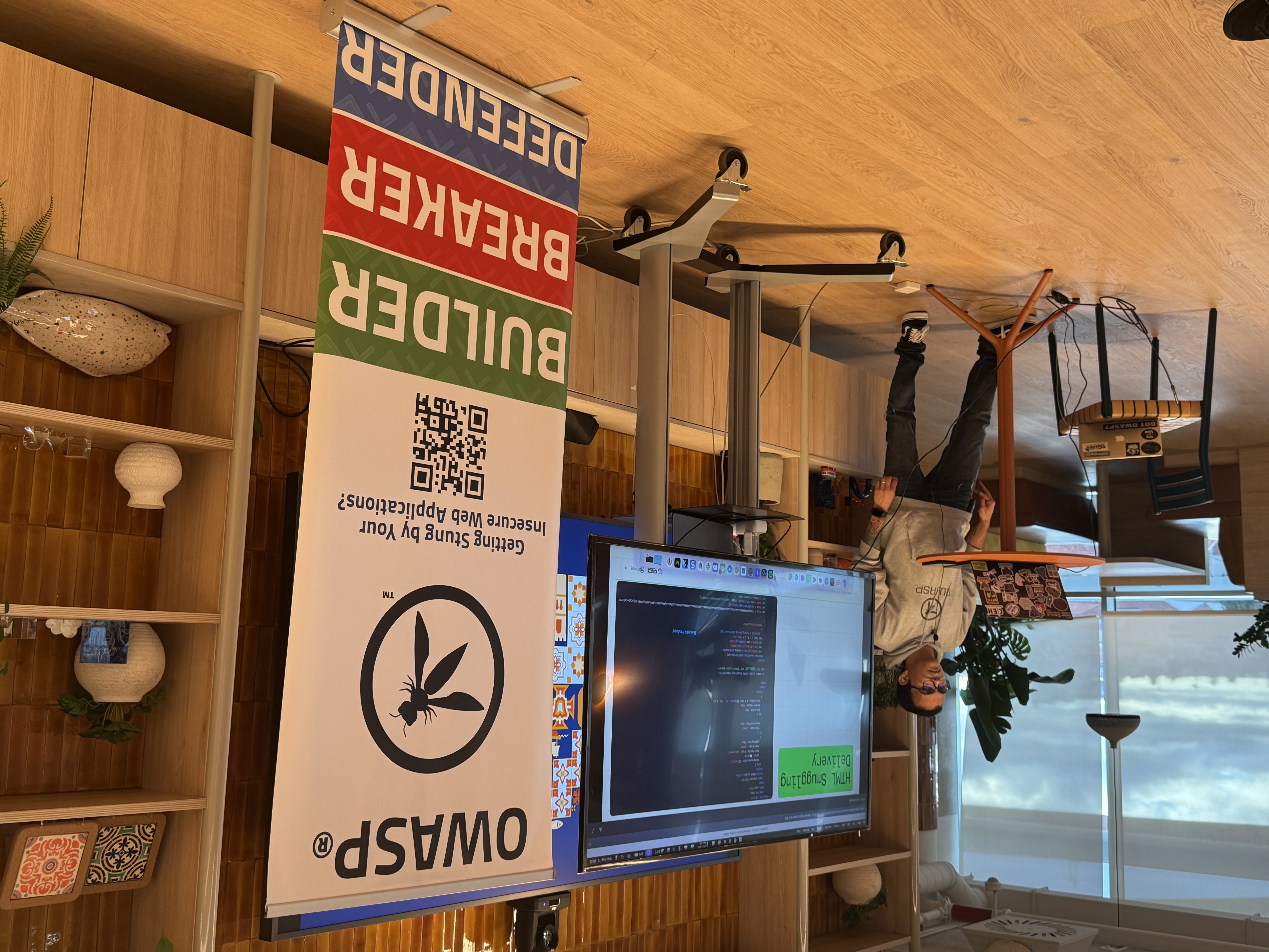 OWASP Lisboa #10 A speaker wearing a grey hoodie and sunglasses presenting a technical demo on a screen titled "HTML Smuggling Delivery."