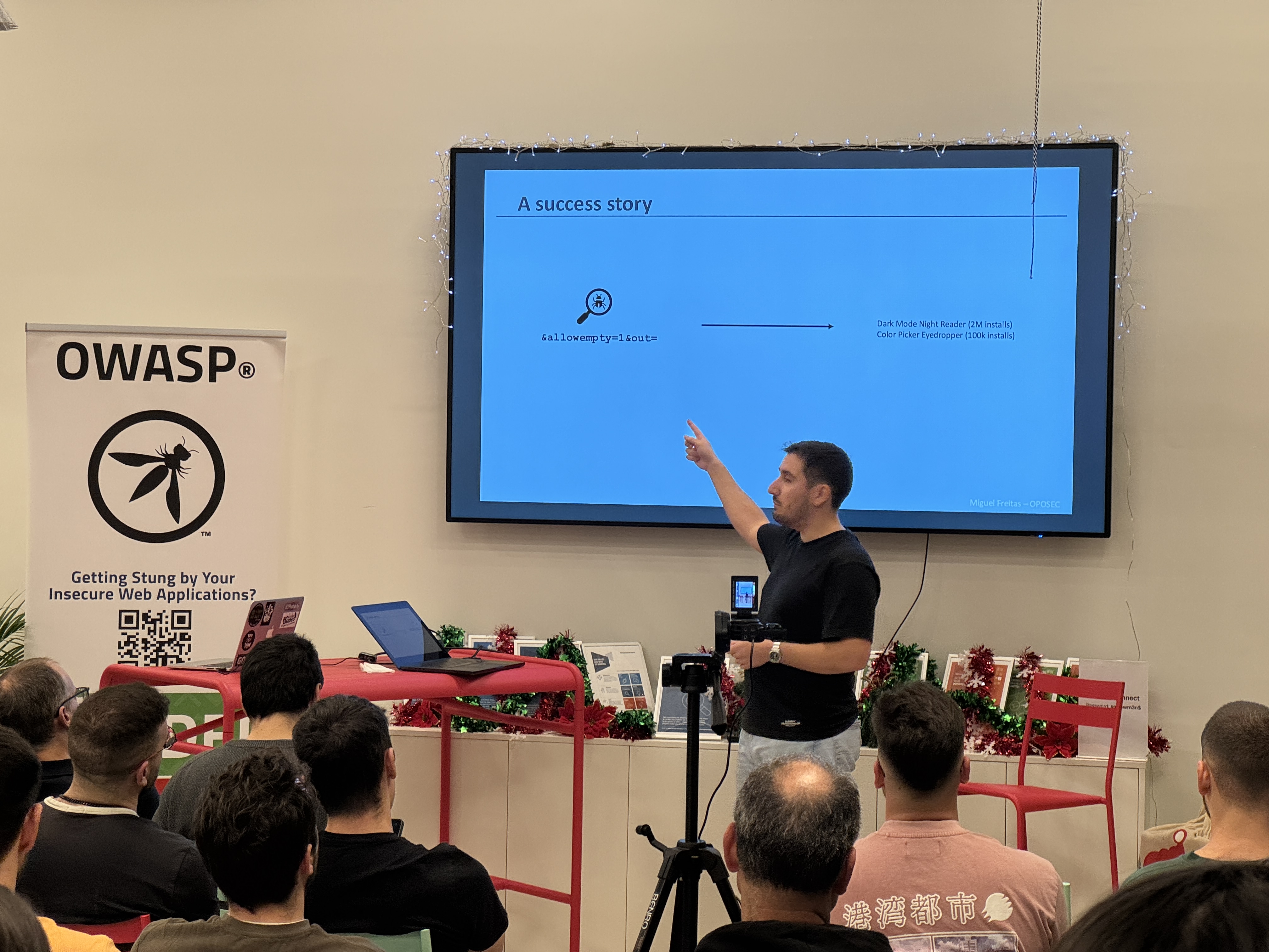 OWASP Lisboa #11 A speaker pointing to a technical slide titled "A success story" showing a diagram of a security flaw discovery involving parameters like "allowempty."